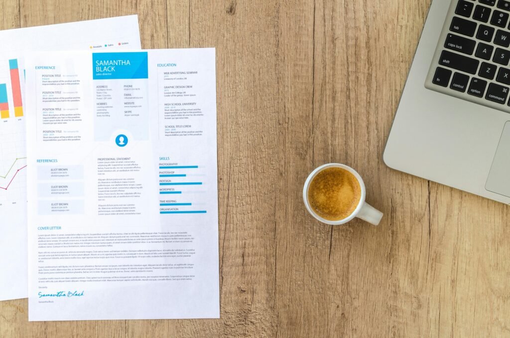 Picture of resume on table with coffee and laptop